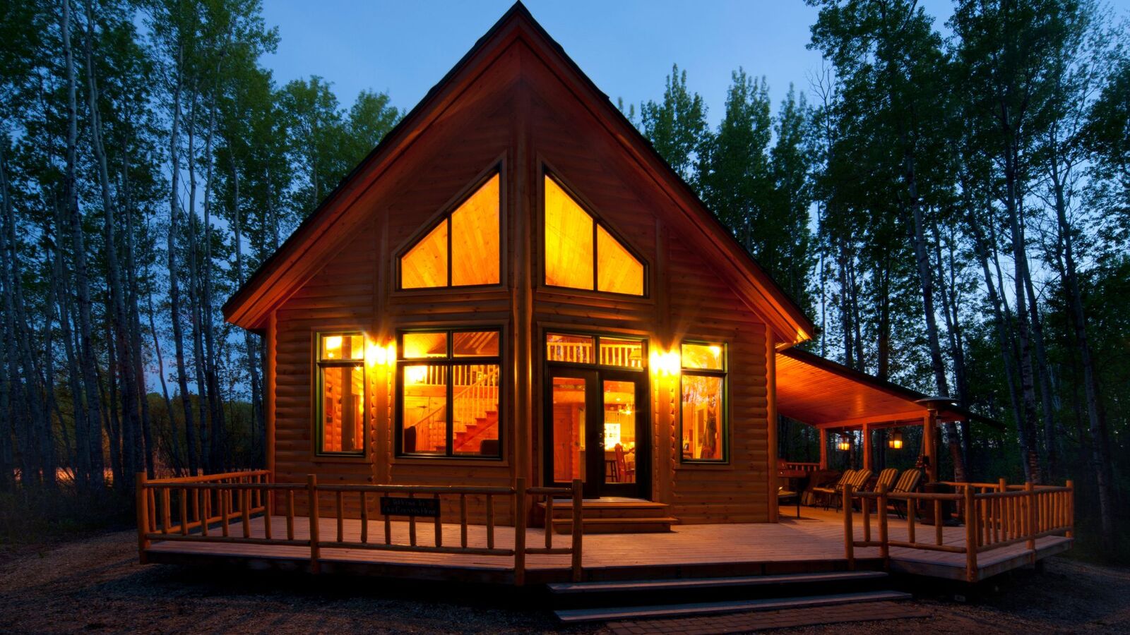 Custom wood deck and railing on a cabin at evening