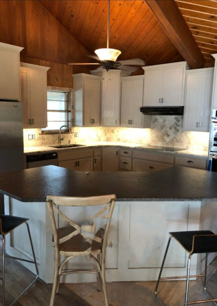 Kitchen remodel with white cabinets and vaulted wood ceiling near Seminole, OK