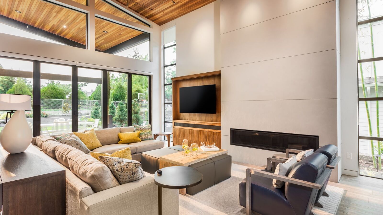 Remodeled living room with vaulted wood ceiling and large windows